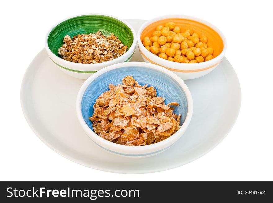 Plate with three kind of cereals for breakfast isolated on white