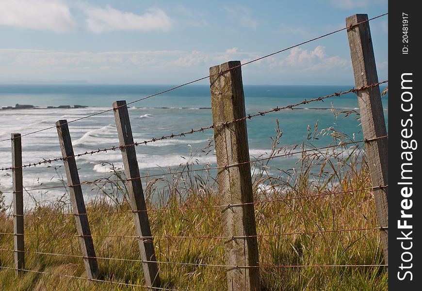 An oceanview from behind a batten fence. An oceanview from behind a batten fence