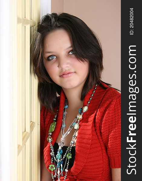 Beautiful brunette female leaning against a door on a sunny day. Beautiful brunette female leaning against a door on a sunny day