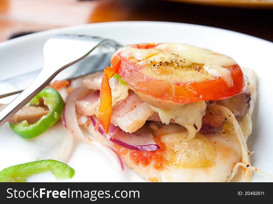 A slice of Pizza with tomato and fork