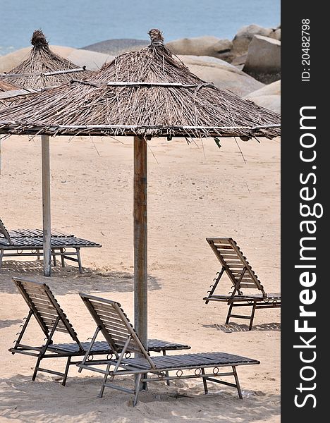 Sunshade and rest chair on sand beach of sea, shown as enjoy holidy on sea beach. Sunshade and rest chair on sand beach of sea, shown as enjoy holidy on sea beach.
