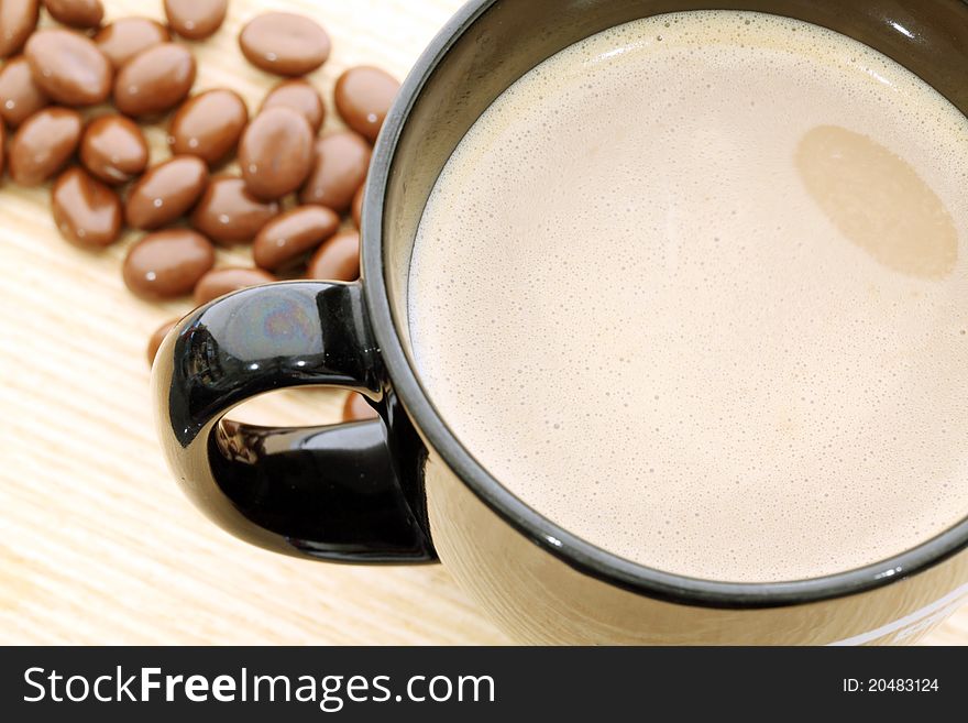 Cup of coffee on wood background.