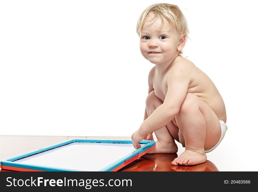 Two years old boy with draw desk on the table. Two years old boy with draw desk on the table