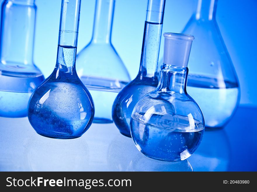 laboratory glassware on the blue background
