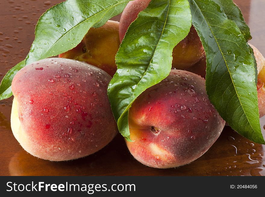 Some biological peaches on a wooden table