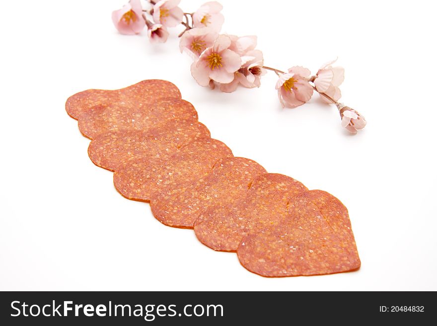 Salami in heart form with flowering branch