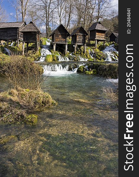 Old wooden watermills on the river. Old wooden watermills on the river