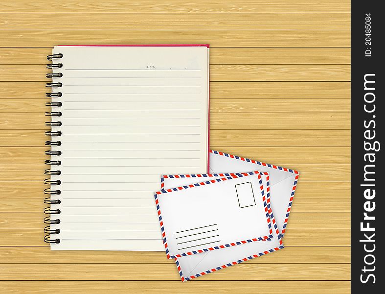 Note book with Old envelopes on wooden background for design-works