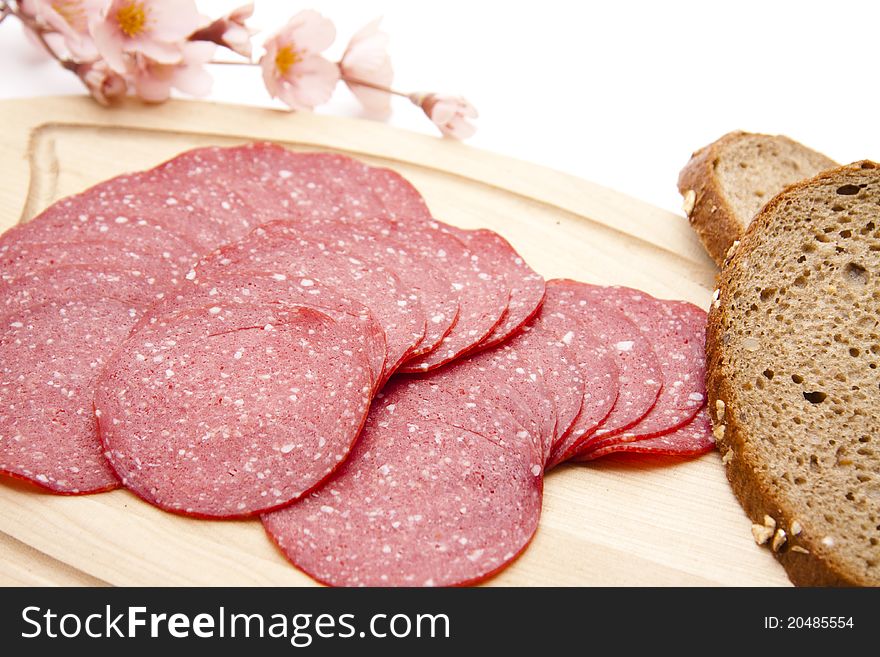 Paprika salami with bread onto white background