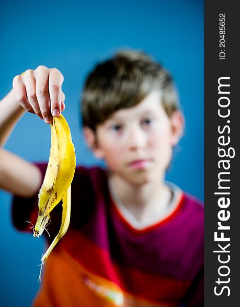 Teenager holding a banana peel