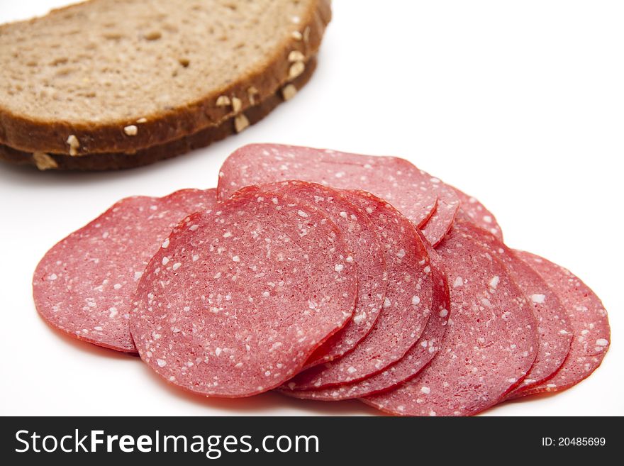 Paprika salami with bread onto white background