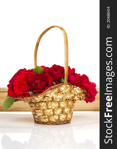 Beautiful red roses in a wicker basket. Isolated. Beautiful red roses in a wicker basket. Isolated