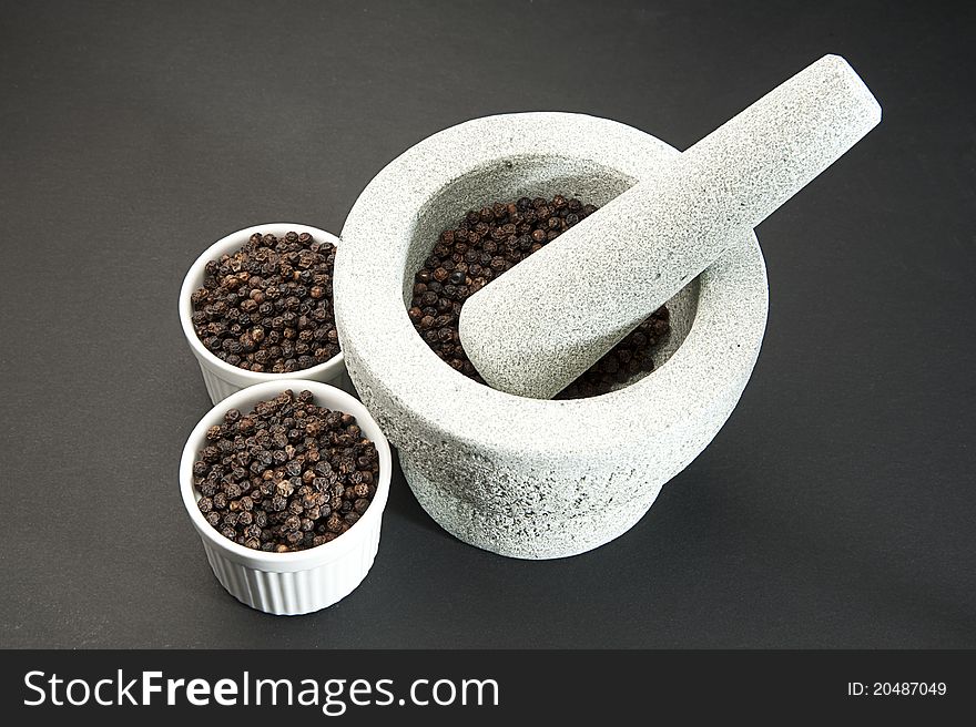 Pestle And Mortar With Black Pepper