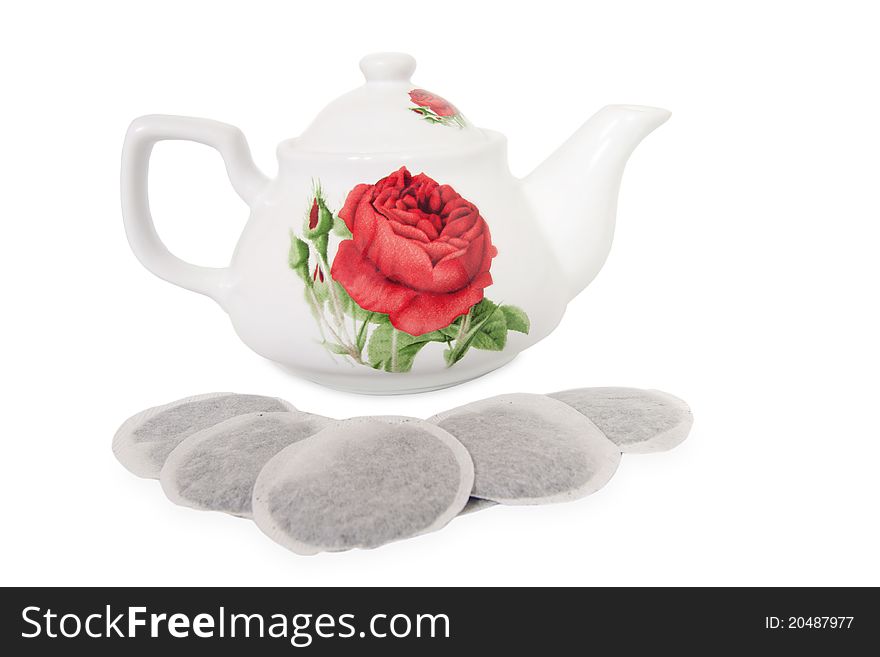 Porcelain teapot and teabags on white background. Porcelain teapot and teabags on white background