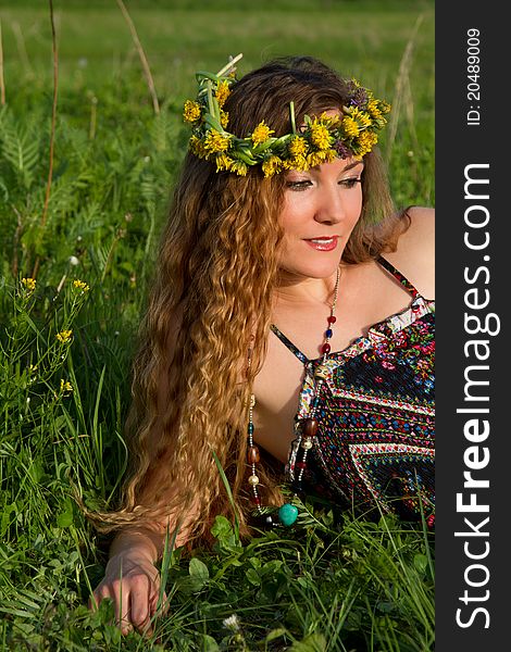 Very beautiful girl in the wreaths of flowers