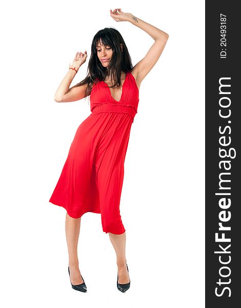 An attractive brunette on a red dress dancing. An attractive brunette on a red dress dancing
