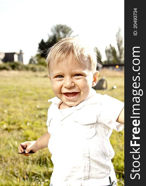 Cute baby smiling and playing outdoor at sunny day. Cute baby smiling and playing outdoor at sunny day
