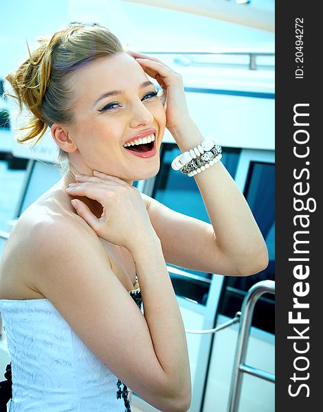 A girl in a summer dress near the boat, sunny day. A girl in a summer dress near the boat, sunny day