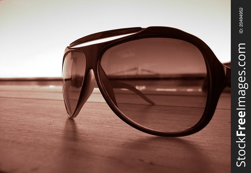 Fashion sun glasses on a wooden table. Fashion sun glasses on a wooden table