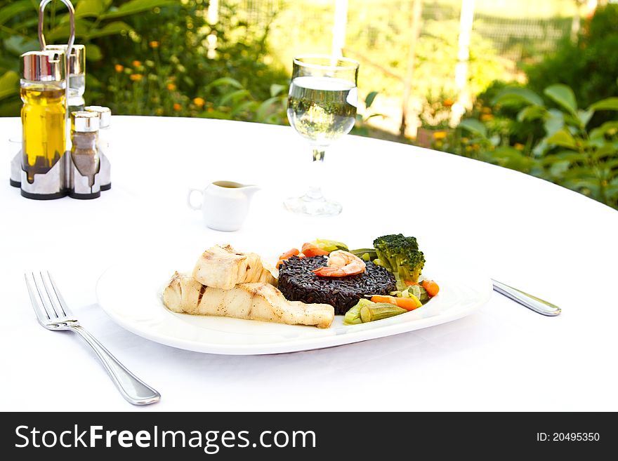 Fish with black rice, vegetables and prawn. Fish with black rice, vegetables and prawn