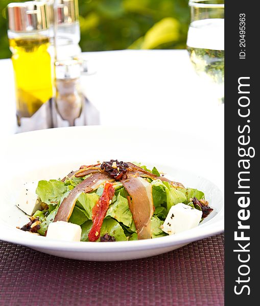 Salad with feta cheese, bacon and nuts
