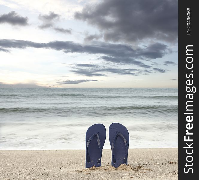 Standing sandals on beach in sunset