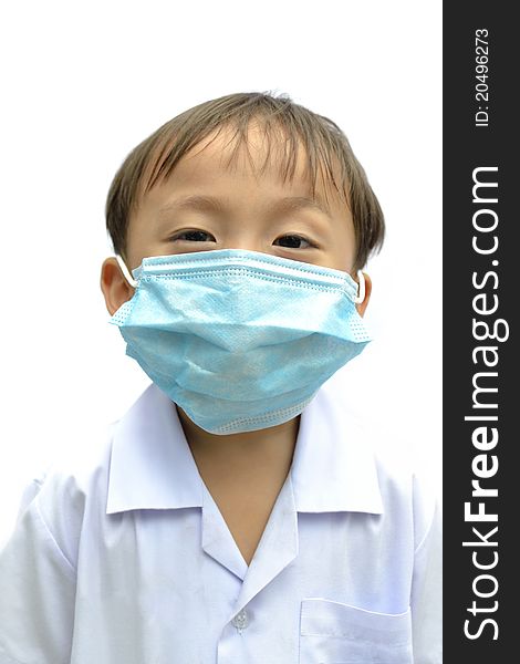 Cute asian young boy wearing disposable face mask on white background. Cute asian young boy wearing disposable face mask on white background.