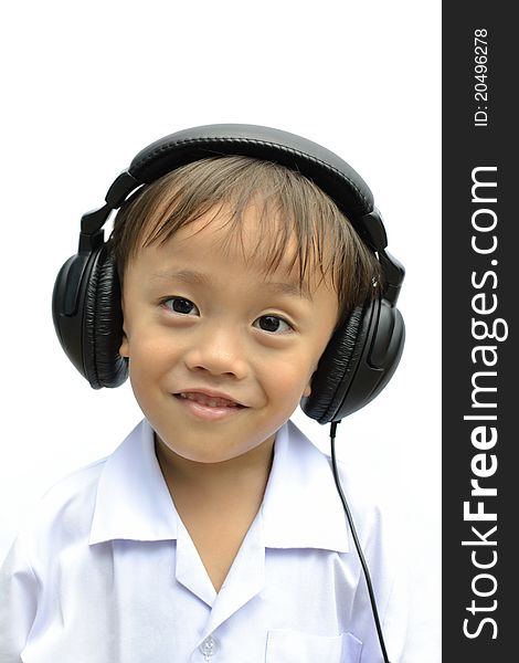 Cute asian young boy using headphone on white background. Cute asian young boy using headphone on white background.