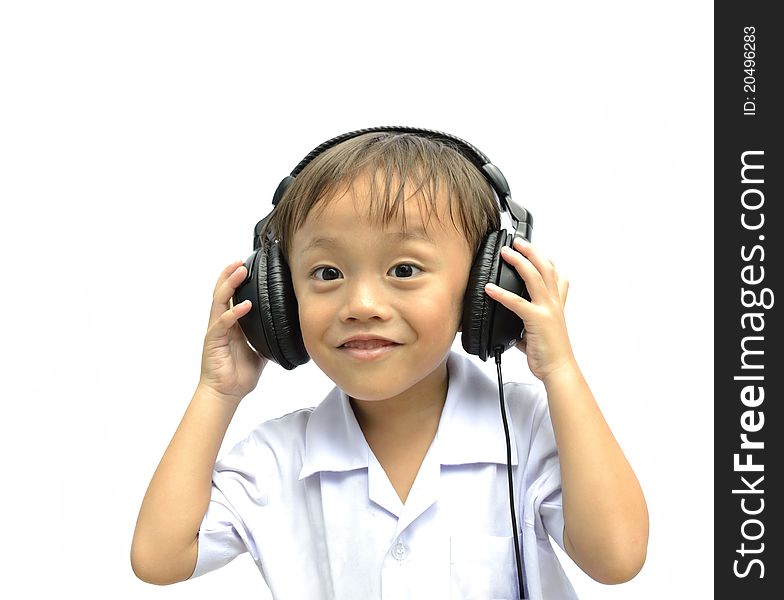 Cute asian young boy using headphone on white background. Cute asian young boy using headphone on white background.