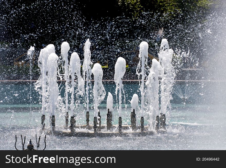 A fountain in a plaza of a city. A fountain in a plaza of a city