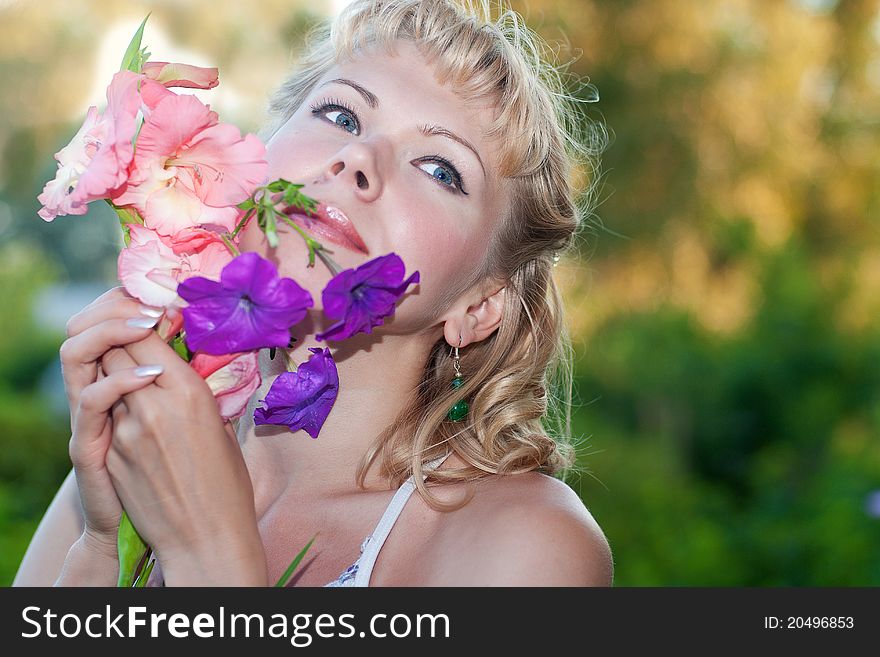 Happy sensual woman with fresh flowers