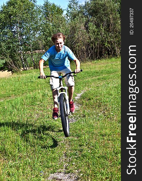 Boy racing with his bike in open