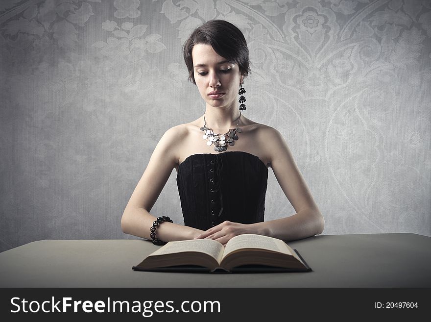 Young beautiful woman reading a book