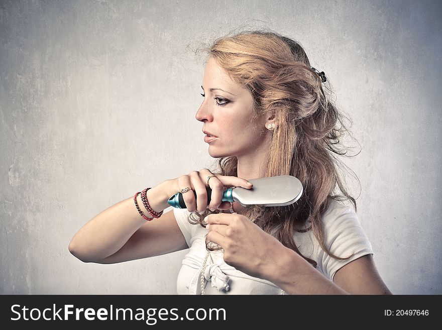 Beautiful woman combing her hair. Beautiful woman combing her hair