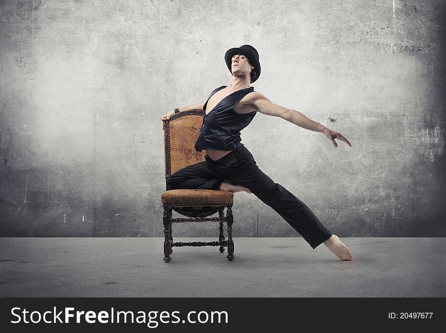 Young man dancing on an old chair. Young man dancing on an old chair