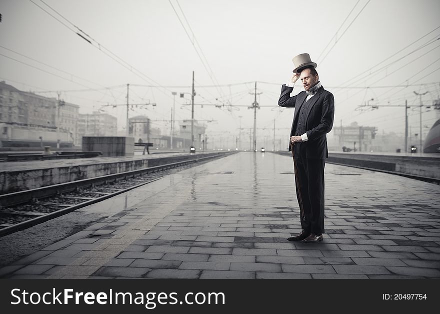 Gentleman standing on the platform of a train station. Gentleman standing on the platform of a train station