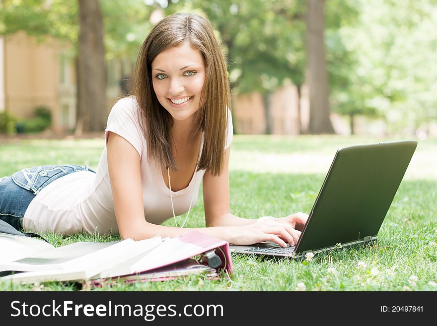 A pretty young college or high school age girl with study materials. A pretty young college or high school age girl with study materials