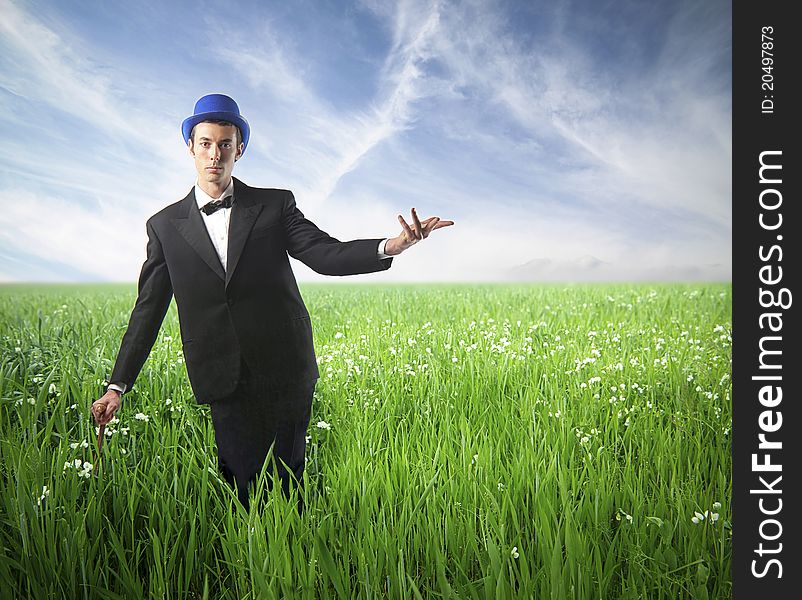 Elegant young man on a green meadow. Elegant young man on a green meadow