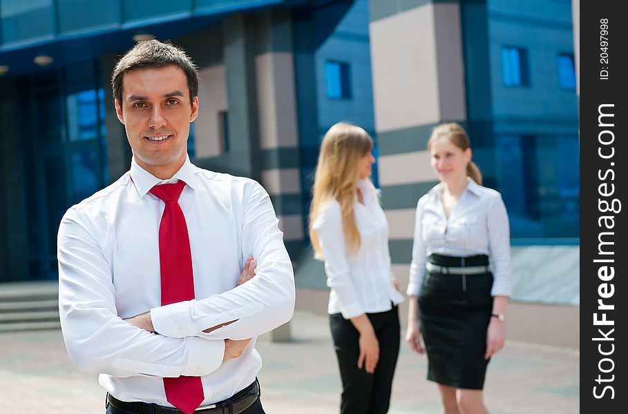 Business people in modern downtown. Cute businessman at foreground.