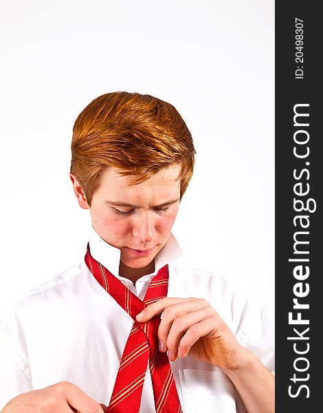 Attractive  teenager  binding his tie. Attractive  teenager  binding his tie