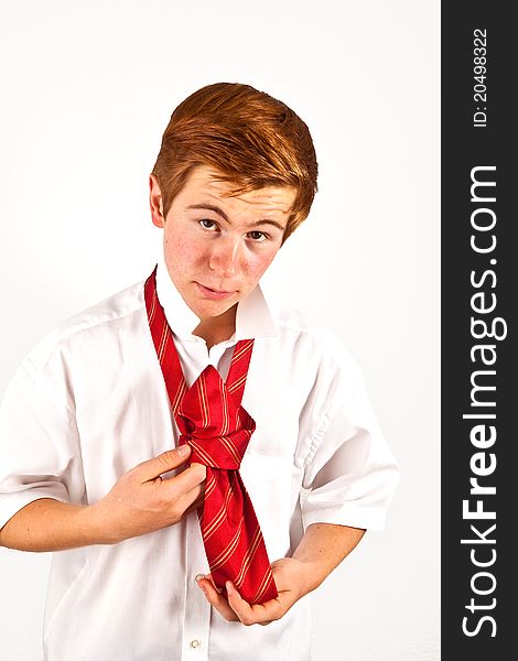 Teenager  binding his red tie