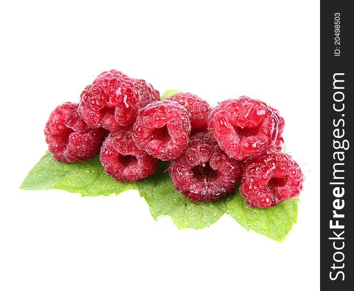 Raspberries: fruits on mint leaves on white background