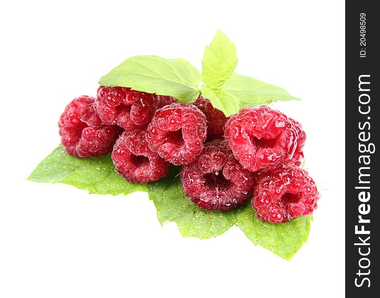 Raspberries: a stack of fruit decorated with mint leaves on white background