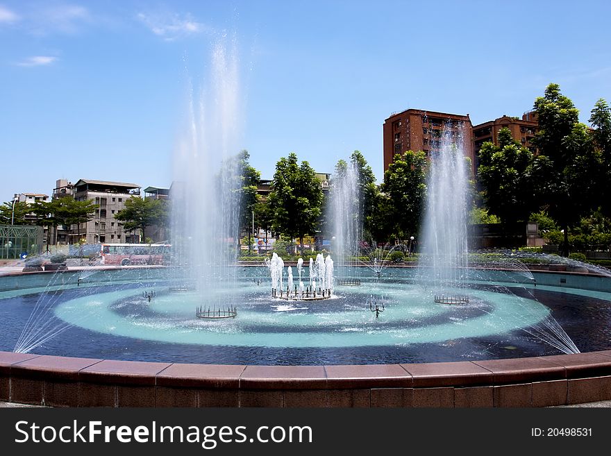 A fountain in a plaza of a city. A fountain in a plaza of a city