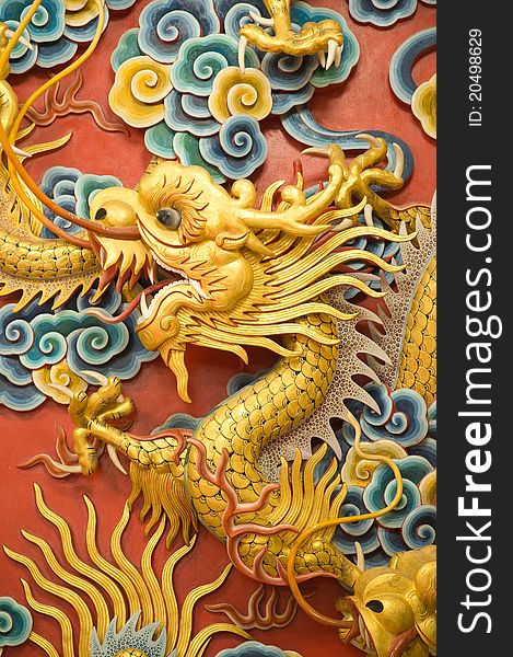 Golden dragon sculpture on Chinese temple wall