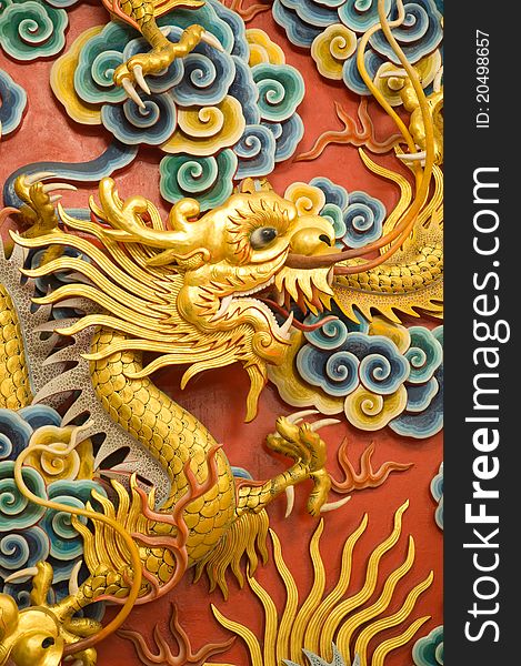 Golden dragon sculpture on Chinese temple wall