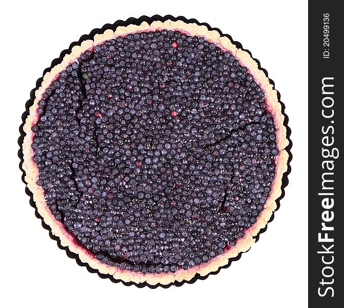 Blueberry Tart in a tart pan on a white background
