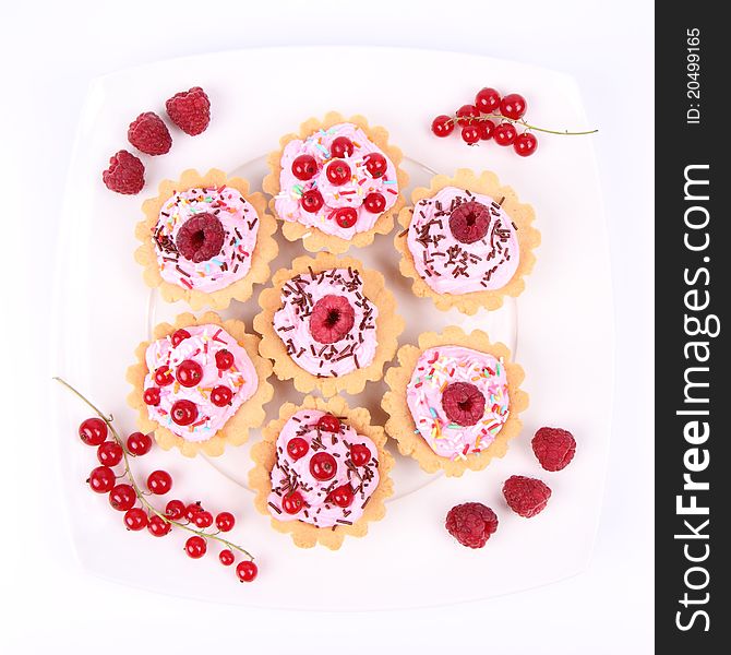 Tartlets with whipped cream, fruits and sprinkles - raspberries and redcurrants