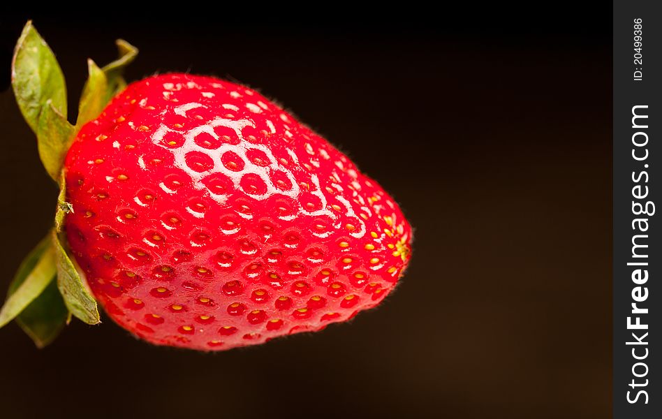 A red strawberry with leaves