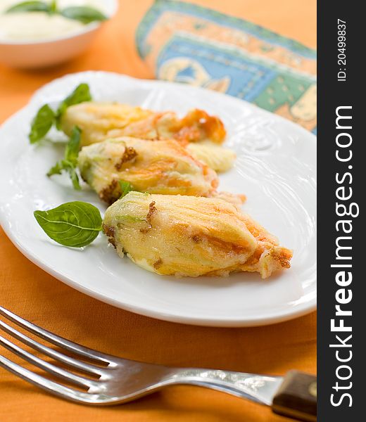 Stuffed zucchini flower on plate. Selective focus